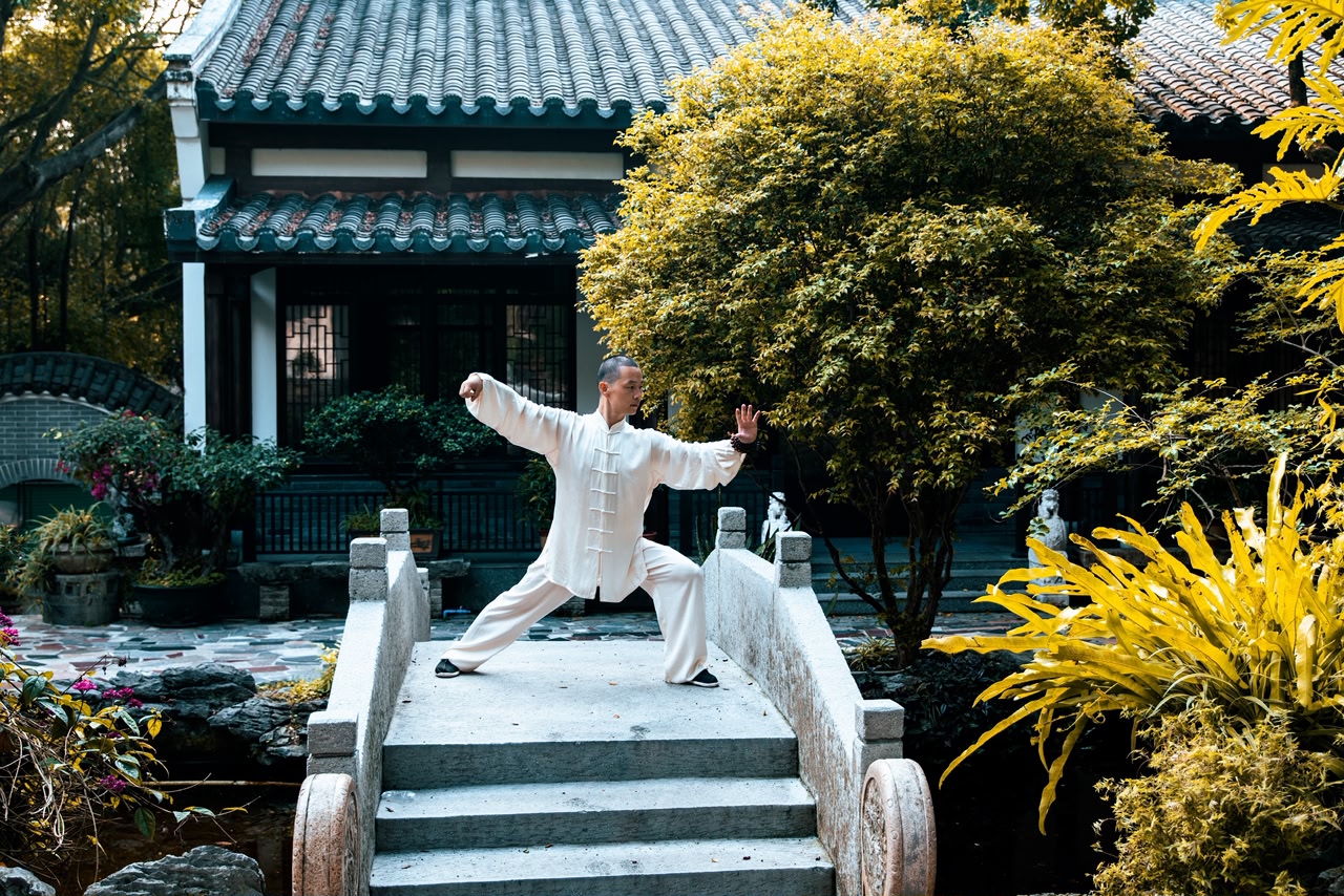 Master Can practicing Tai Chi on temple bridge